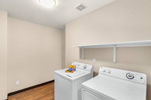 A small laundry room with a washer and dryer.