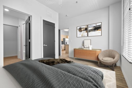 a bedroom with a bed and a chair in a 555 waverly unit