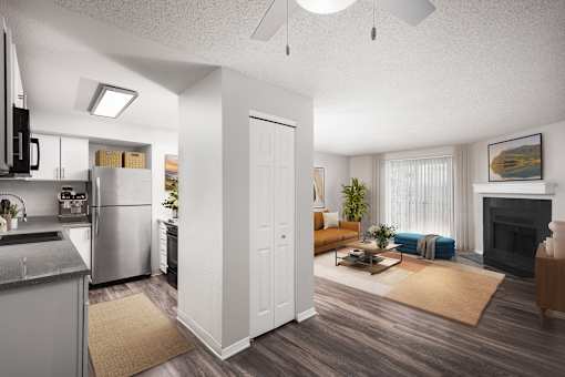 A modern kitchen with a refrigerator, microwave, and oven.