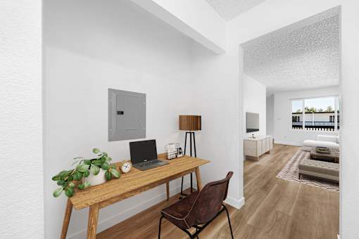 A room with a desk and a laptop on it.