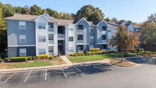 parking lot with apartment building in background