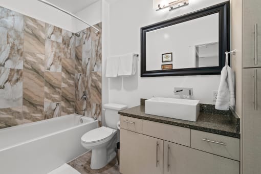 Bathroom with above-counter sink and bath/shower combination