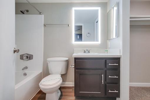 A white toilet sits next to a sink in a bathroom.