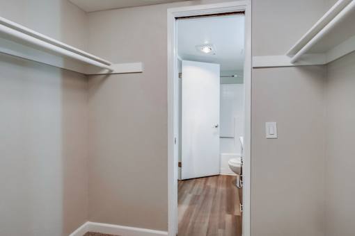 A white door is open to a bathroom.
