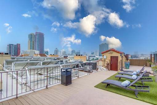A rooftop patio with a view of the city skyline.