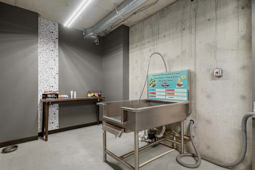 A stainless steel table with a sign on the wall behind it.