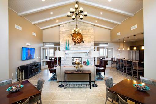 A large dining room with a fireplace and a television.