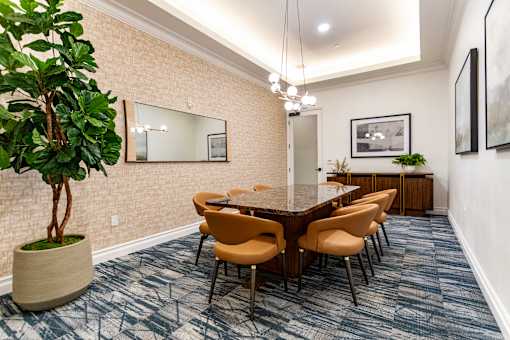 A conference room with a long table and chairs.