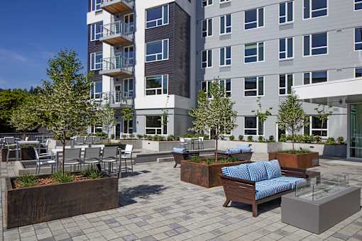 A modern building with a patio area in front.