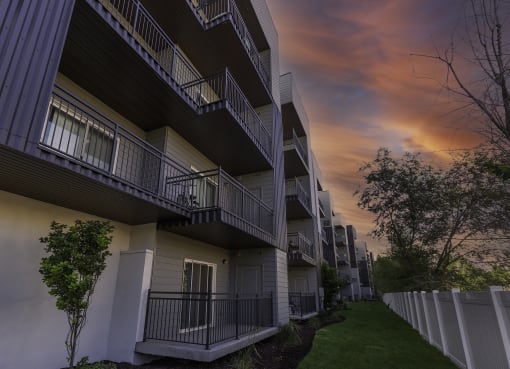 a row of apartments with balconies at sunset