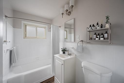 Dog-Friendly Affordable Apartments in San Mateo, CA - Hillsdale Garden - Bathroom with a Garden-Style Tub, a Floating Shelf, and a Window