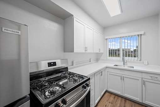 A kitchen with a fridge and a stove at Hillsdale Garden Apartments, CA 94403