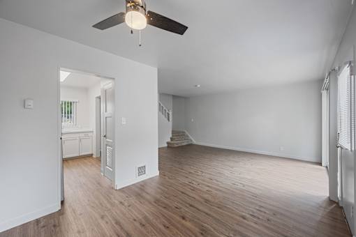 A room with a ceiling fan and wooden floors at Hillsdale Garden Apartments, 94403