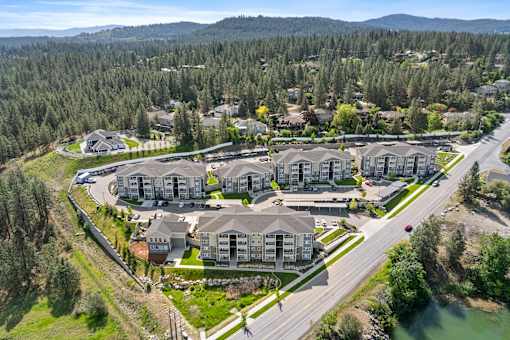 A bird's eye view of a residential area with houses and a river.