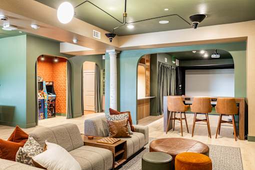 A living room with a grey couch and a wooden coffee table.