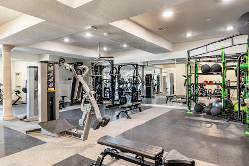 A gym with a variety of equipment including a leg press machine.