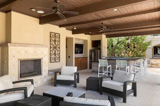 A patio with a fireplace and furniture.