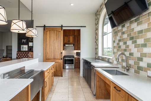 A kitchen with wooden cabinets and a tile backsplash.