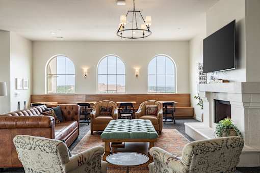 A living room with a fireplace and a large screen TV.