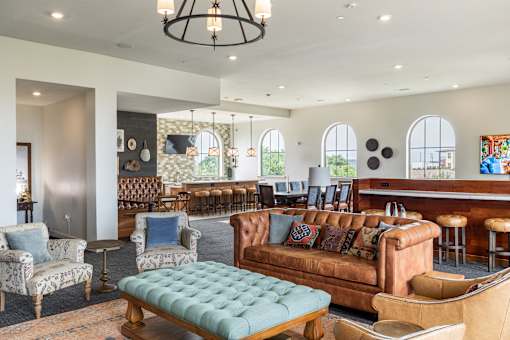 A large room with a couch, chairs, and a table.