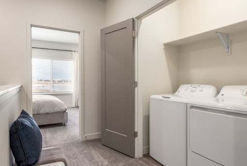 a washer and dryer in a room with a bedroom