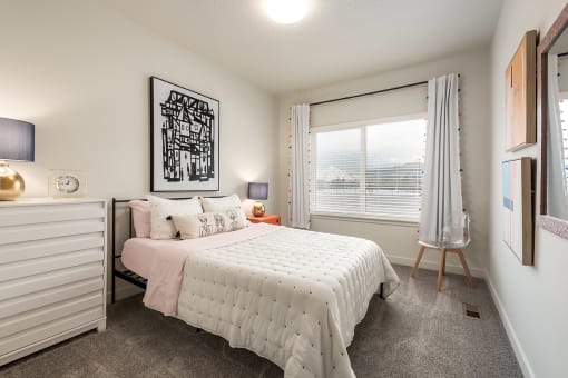a bedroom with a bed and a window