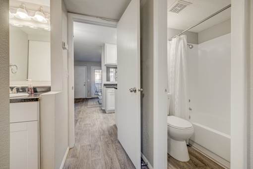 A white bathroom with a toilet and a shower.