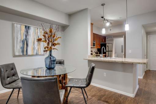 A dining room with a glass table and chairs.
