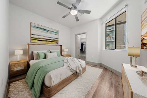 A bedroom with a large bed and a ceiling fan.