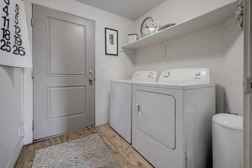 A small laundry room with a washer and dryer.