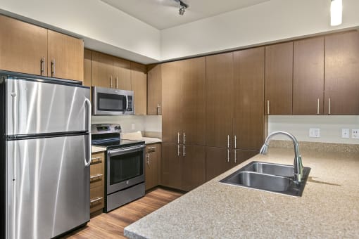 a kitchen with wooden cabinets and stainless steel appliances at Allez, Washington, 98052