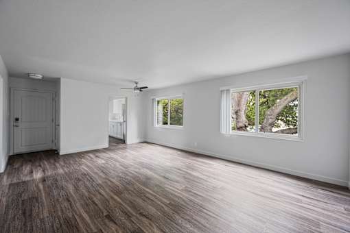 A room with a ceiling fan and two windows at Hillsdale Garden Apartments, San Mateo, CA 94403
