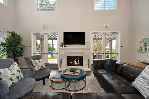 A living room with a fireplace and a flat screen TV.