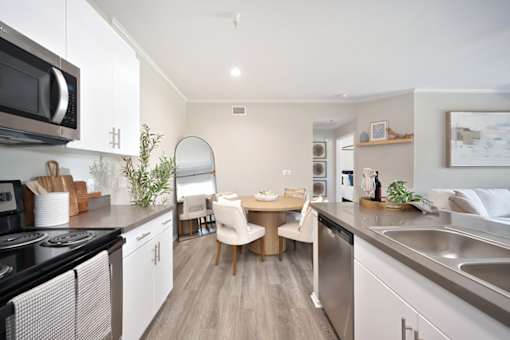 A modern kitchen with a dining table and chairs.