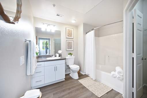 A bathroom with a toilet, sink, and bathtub.