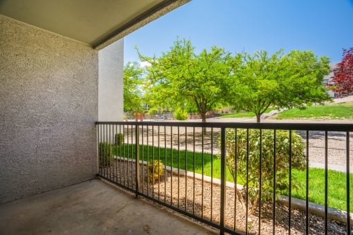 a balcony with a view of the grassy area and trees at Odyssey Ridge, Albuquerque, NM  