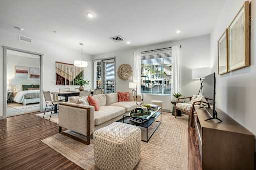 A modern living room with a sofa, armchair, and coffee table.