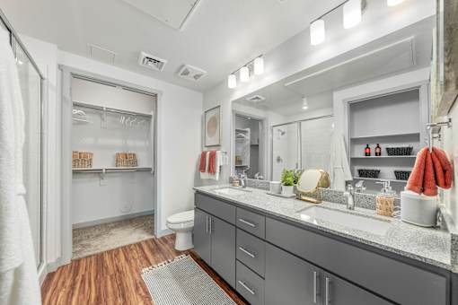A bathroom with a white toilet, a sink, and a mirror.