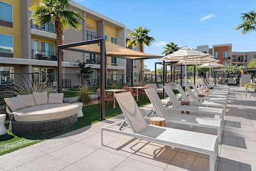 A sunny day at the outdoor seating area of a modern apartment complex.