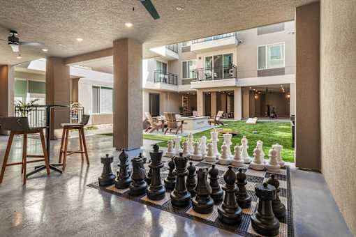 A chess board with pieces on it in a room.
