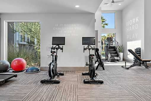 A gym with a motivational quote on the wall.
