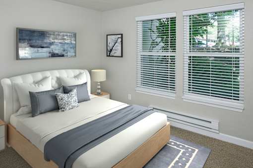 A bedroom with a large bed and a painting on the wall.