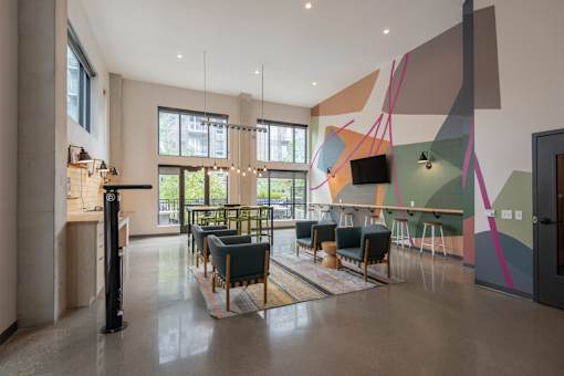 A modern room with a long table and chairs.