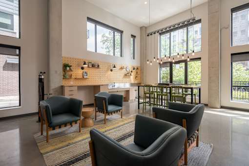 A living room with a couch, chairs, and a table.
