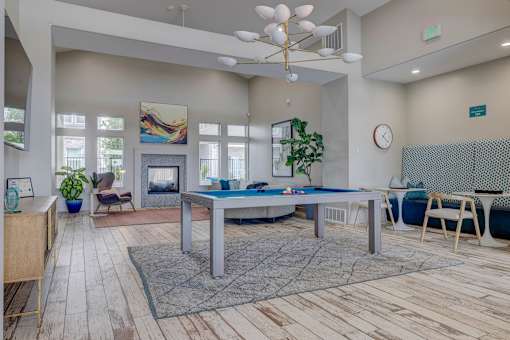 A room with a pool table and a chair.