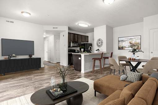 A living room with a brown couch and a black coffee table.