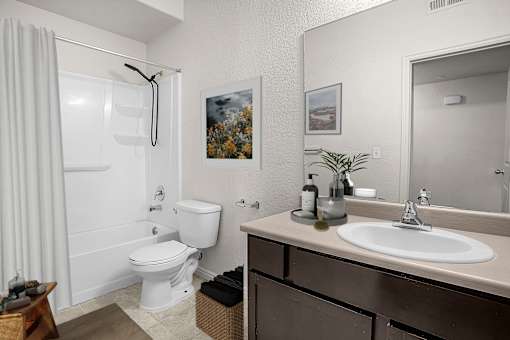 A bathroom with a white toilet and sink.