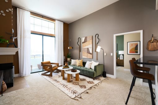 a living room with a green couch and two tables