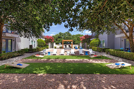 A playground area with a slide and swings in a residential area.