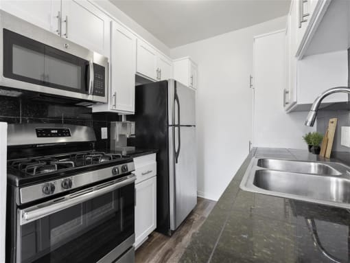 a kitchen with a stove top oven next to a sink at Pacific Rose, Los Angeles California